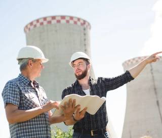 male-architects-reviewing-documents-together-electric-power-plant